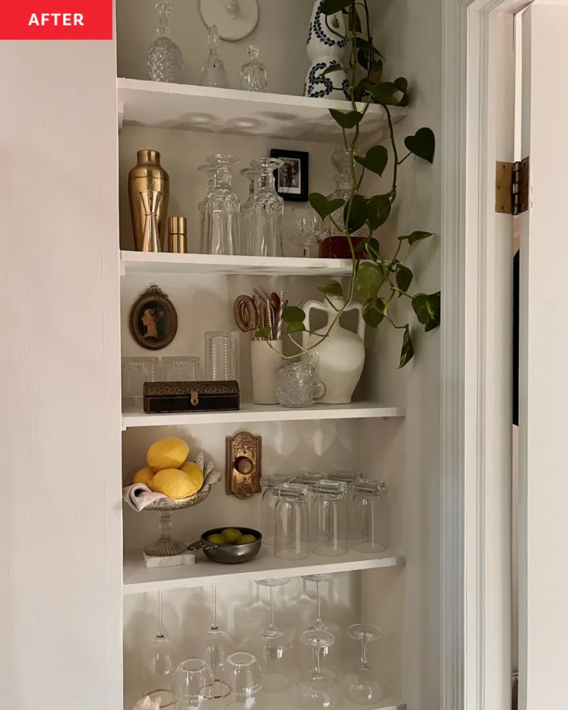   칼리 풀러's built-in looking kitchen nook shelves painted to match her light walls and styled with plants, dishes, and glassware